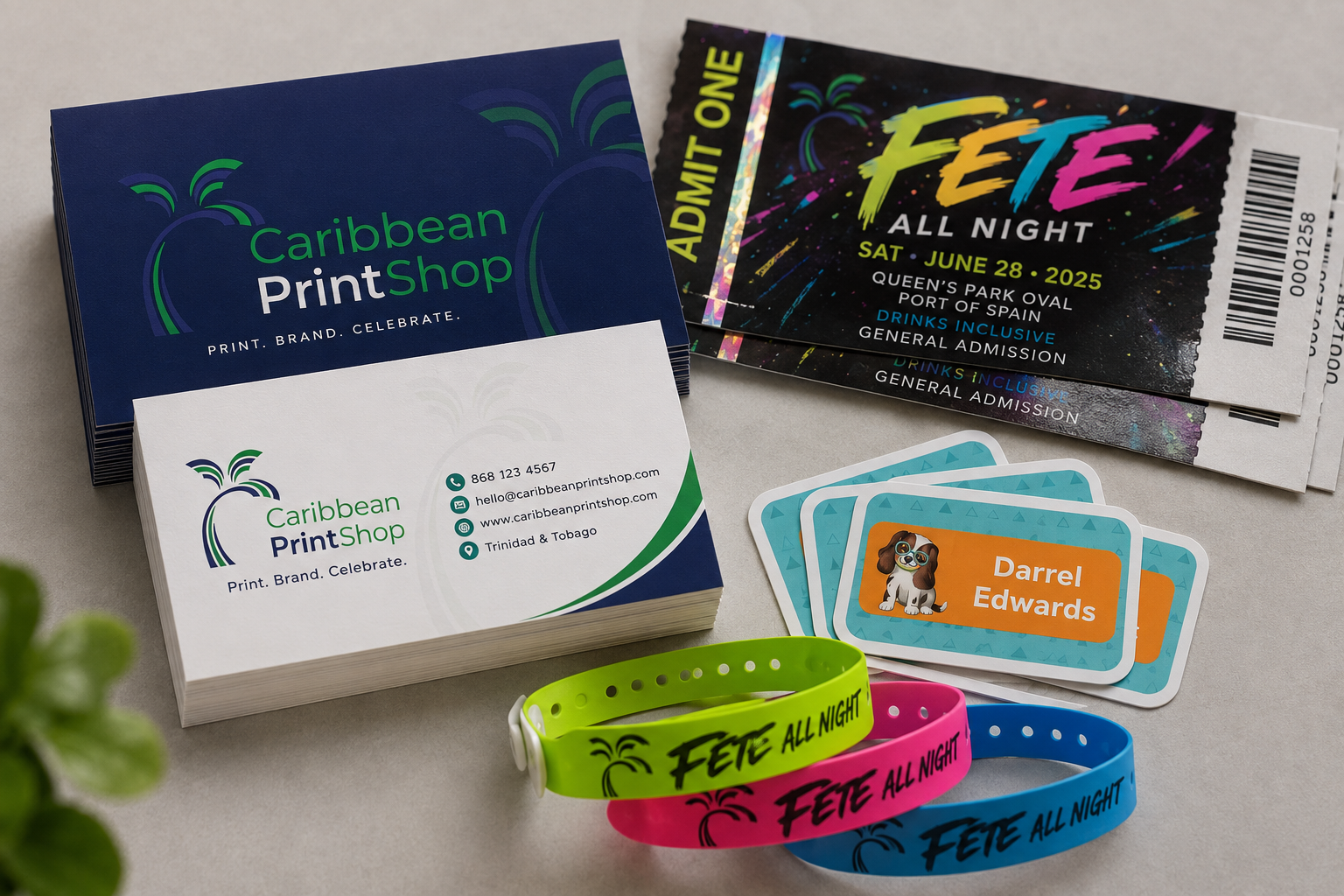 Prompt: editorial overhead photograph of beautifully printed Caribbean business cards, event tickets, and colorful wristbands arranged on a warm neutral studio surface, navy blue and vivid green brand accents, natural soft light, premium commercial print quality, no text distortion